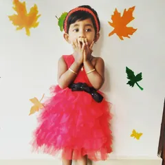 Our little princess Pari looking absolutely surprised and delighted in her custom outfit. This red ruffled dress was designed for a Mickey Mouse themed party.