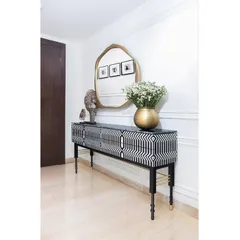 The Lella Sideboard from our Koko by K2India collection is a statement of our love for handcrafted detail. The bold, graphic inlay work paired with the sculptural Soho Mirror demonstrates how we use bespoke furniture not just as an object, but as the powerful focal point of a room's story.