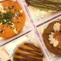 A closer look at the variety in our Rakhi assortment box. You can see the rich toppings on the Korean bun, the creamy Biscoff cookie, the chocolate drizzle on the bombolini, and the unique texture of the kunafa cheesecake.