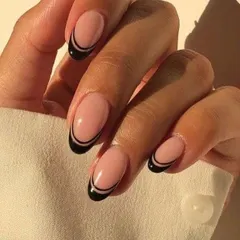 For a chic and minimalist look, I created this double-line black French tip on a rounded oval nail shape. It's sophisticated with a modern edge.