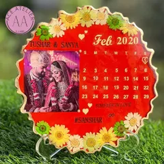 This vibrant red wedding calendar frame is a perfect way to celebrate love. It features the couple's photo, their wedding month, and is surrounded by real, colorful dried flowers.