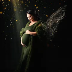 An angelic portrait in the green gown, with added light effects and golden wings. This turns a maternity photo into a magical piece of art, celebrating the miracle of life.