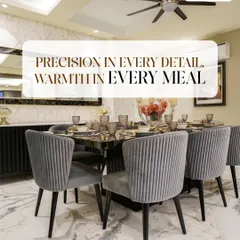 Precision in every detail creates warmth in every meal. This dining setup features comfortable, upholstered chairs and a sleek marble top table, ready for family gatherings.