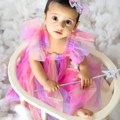 A close-up of our little fairy, holding her magic wand. Her curious expression and beautiful dress make this a truly special portrait.