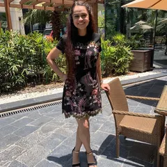 Enjoying a sunkissed moment in this embroidered black dress. It's a versatile piece that works beautifully for a daytime event, with the colorful embroidery adding a pop of personality.