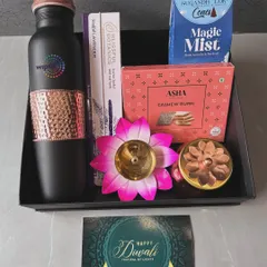 A festive corporate hamper designed for Wipro, combining utility with tradition. This Diwali gift includes a branded copper-accented bottle, Indian sweets (Cashew Burfi), incense cones, and a decorative lotus diya.