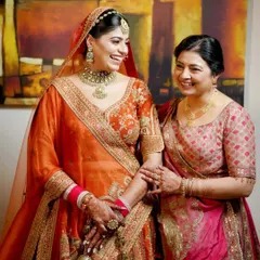 A candid photograph of a bride sharing a moment of pure laughter with her mother. Capturing these warm, genuine connections is central to our documentary style of family photography.