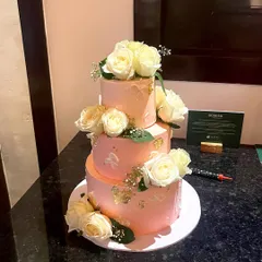For grand celebrations, I love creating tiered cakes like this one. This three-tiered beauty features a vanilla sponge, is filled with fresh strawberry and blueberry filling, and is decorated with fresh white roses and delicate gold leaf accents.