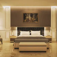 A modern bedroom combining classic and contemporary elements. The design features wall paneling, a tufted headboard, and warm ambient lighting from the fluted wall panel and floor lamp to create a cozy yet sophisticated retreat.