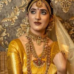A close-up of the bridal look, showing the intricate details of the matha patti and nose ring.