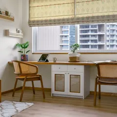 This two-person workspace in the 'Malhar' home office is perfect for a couple working from home. The long desk provides ample room, while the central cabinet with cane shutters adds storage and texture.