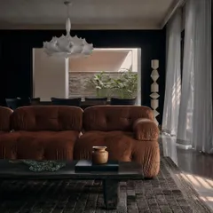 This living space from The Grove Residence in Bangalore captures our philosophy of slow living. The plush, earth-toned sofa and minimalist coffee table create a setting for quiet contemplation, where the focus is on comfort, texture, and the subtle interplay of light from the window.