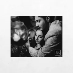An intimate and artistic black and white close-up. The soft focus and tight crop draw all the attention to the couple's tender embrace.