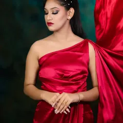 A full-body shot showing how the red satin dress complements the makeup for a complete, cohesive look.