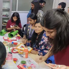 A group of enthusiastic participants at a fabric painting workshop. It is a wonderful activity for team building and de-stressing.