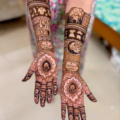 A personalized baby shower mehendi featuring portraits, names written in Tamil script ("Amma" and "Appa"), and symbolic elements like a mother cow with her calf.