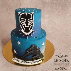 A powerful Black Panther two-tier cake for a superhero fan. This 1.5 kg Vanilla Caramel cake has a cool blue ombre finish and is decorated with the Black Panther mask and silhouette.
