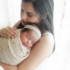 There's a special joy in seeing a family grow. Holding her newborn daughter, this mother's love shines through. It's an honor to document these stories from maternity to newborn sessions.