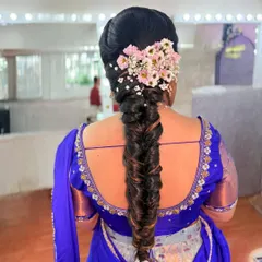 A beautiful fishtail braid adorned with fresh flowers for an engagement ceremony. This hairstyle is both modern and traditional, perfect for any special occasion.