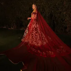 A bride's entry is a story in itself. This breathtaking full-length shot captures the grandeur of a deep red velvet lehenga with a magnificent trail, a look I created to be as epic and memorable as the day itself.