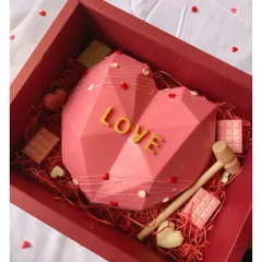 Piñata cakes are always a hit! This geometric heart is made of chocolate and comes with a small hammer to smash it open and reveal a surprise inside.