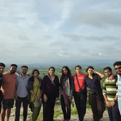 The group enjoying the sunset view from Hemakuta Hill in Hampi, with a panoramic view of the ruins below.
