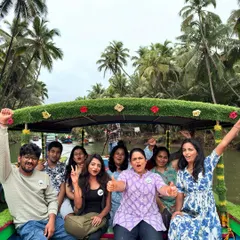 A cheerful group enjoying a decorated boat ride through the Honnavara backwaters. It's a relaxing and scenic part of my coastal escape package.