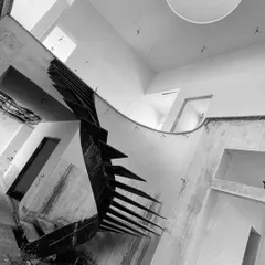 An upward view of the helical staircase during construction. The spiraling steel structure, based on the Fibonacci sequence, is a testament to our interest in creating functional art through complex engineering.