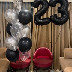 Cheers to 23! We designed this elevated birthday balloon arrangement with a sleek black and silver theme, featuring giant number balloons and a matching bouquet for a sophisticated celebration.
