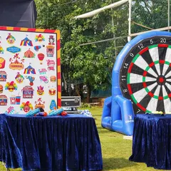 For a fun-filled pre-wedding event, I set up a carnival games area. This included an inflatable dartboard and other classic games to keep guests of all ages entertained.