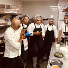 Another moment from a kitchen briefing. This is where we ensure that every dish that leaves the kitchen meets our exacting standards of quality and presentation.