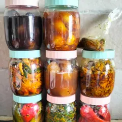 A colourful lineup of my homemade pickles, each jar filled with a different taste of home. You can see the variety, from the dark sweet lemon pickle to the bright red chilli and golden mixed vegetable achars.