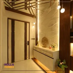The entrance to our Maharashtrian-themed home. We used a combination of textured walls, warm lighting, and a Ganesha idol to create a welcoming and auspicious entryway.