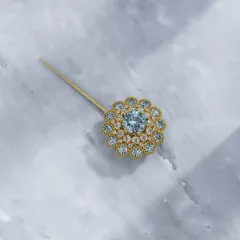 Another view of the aquamarine and diamond floral pin, showing its sparkle from a different angle. It is made to feel like it has always been yours.