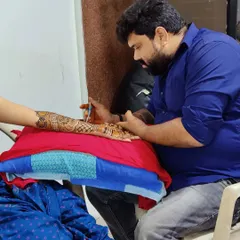 Concentration and proper technique are key. This image captures a moment of detailed application during a class, where I teach the precise pressure and movement needed for clean, consistent henna art.