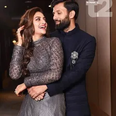 This couple showcases a chic, modern look perfect for a cocktail party. The man wears a sharp navy blue bandhgala jacket, demonstrating a sophisticated and contemporary approach to ethnic wear.