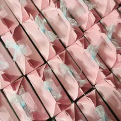 An overhead shot of the neatly arranged pink return gift boxes. I ensure every single favor is perfectly assembled for a uniform and professional look.