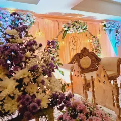 A close-up view of the floral work for an engagement stage. I used a mix of purple and white chrysanthemums and pink carnations to create a lush, multi-layered look that flows from the floor up to the main arch.