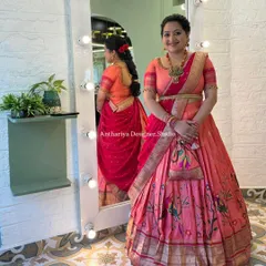 A full view of the mother's beautiful Maharani Paithani lehenga, complete with a matching potli bag.