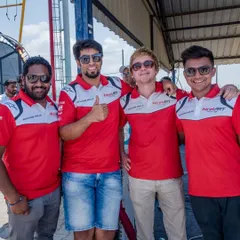 Key members of our team, including drivers and management, at the track. A strong, collaborative team is the backbone of our success.