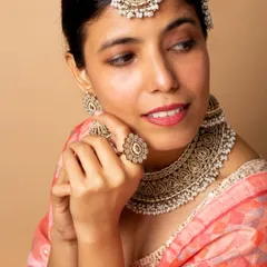 A delicate, expressive pose that highlights the intricate details of the bridal ring, earrings, and necklace, perfect for jewellery catalogue work.