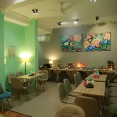 Can you feel the warmth like I do? The cafe is set up with soft lighting and comfortable seating for a relaxing experience.