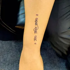 A clean and simple script tattoo of 'Ant asti prarambh' on the forearm. The minimalist font choice makes this profound message both elegant and readable.