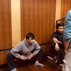 A candid moment during a break in rehearsals in Mumbai. The process involves long hours, but also moments of rest and camaraderie with fellow artists.
