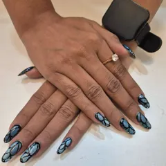 This is where nails become art. I designed this intricate, multi-tonal blue and black pattern on long almond-shaped extensions. This style is perfect for when you want a truly unique and eye-catching look that expresses your personality.