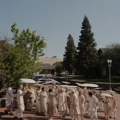The Baraat procession for Nita and Navi's Sikh wedding in California. The coordinated umbrellas and outfits create a visually stunning and unified look.
