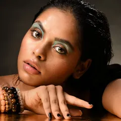 This angle highlights the glossy skin texture and the raw, edgy feel of the overall look.