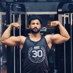 If you want better results, you have to make better choices. A classic front double biceps pose, showcasing arm and shoulder development after a solid upper body workout.