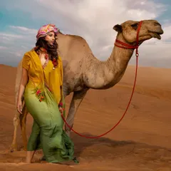 Creating a magical moment with a friendly camel. This shot adds a layer of storytelling and local flavor to the fashion editorial.
