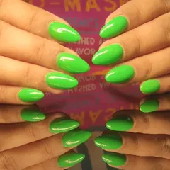 An electrifying neon green manicure on almond-shaped nails that is guaranteed to turn heads.